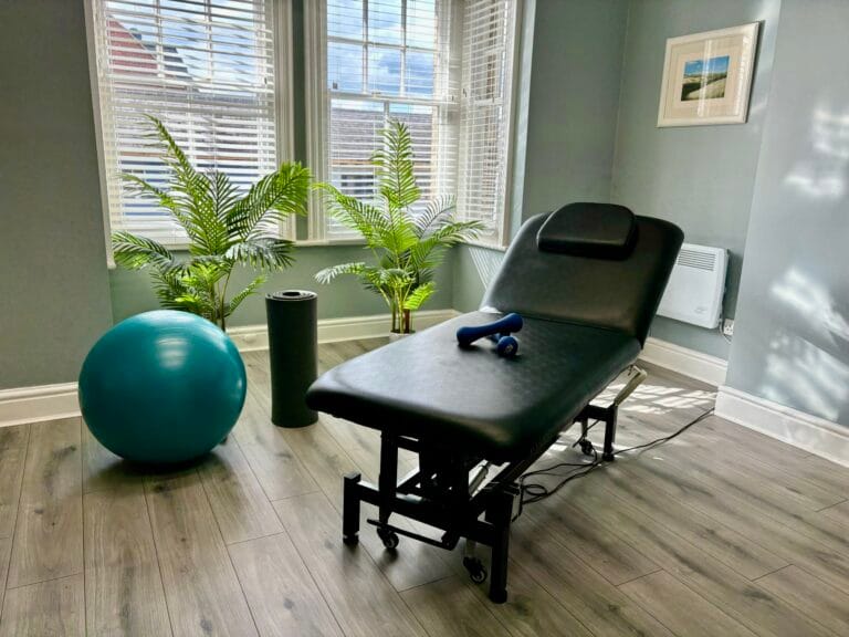 Physiotherapy room with treatment couch and exercise equipment