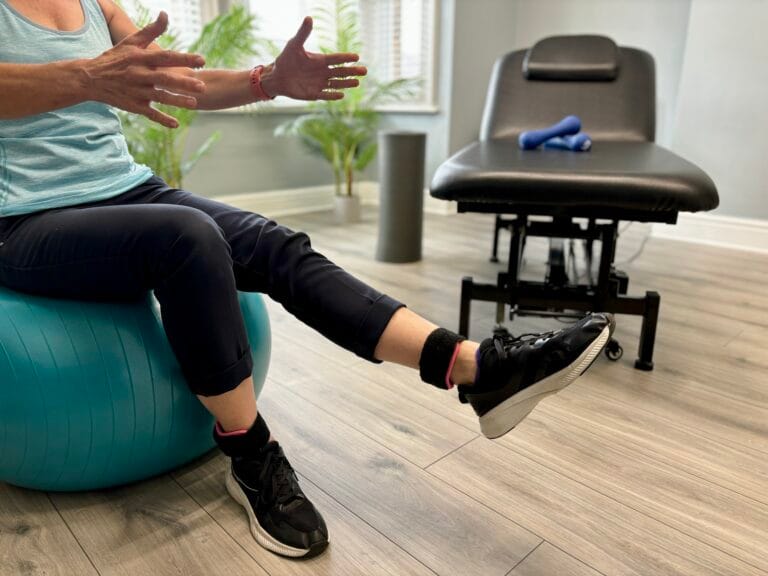 Person exercising on stability ball in physiotherapy clinic