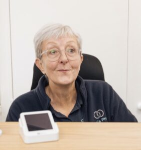 Smiling woman sitting at a desk.
