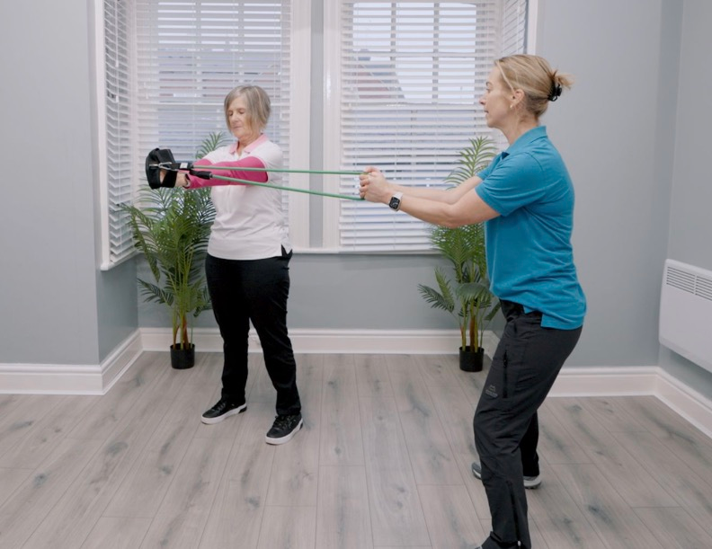 Two women exercising with resistance bands