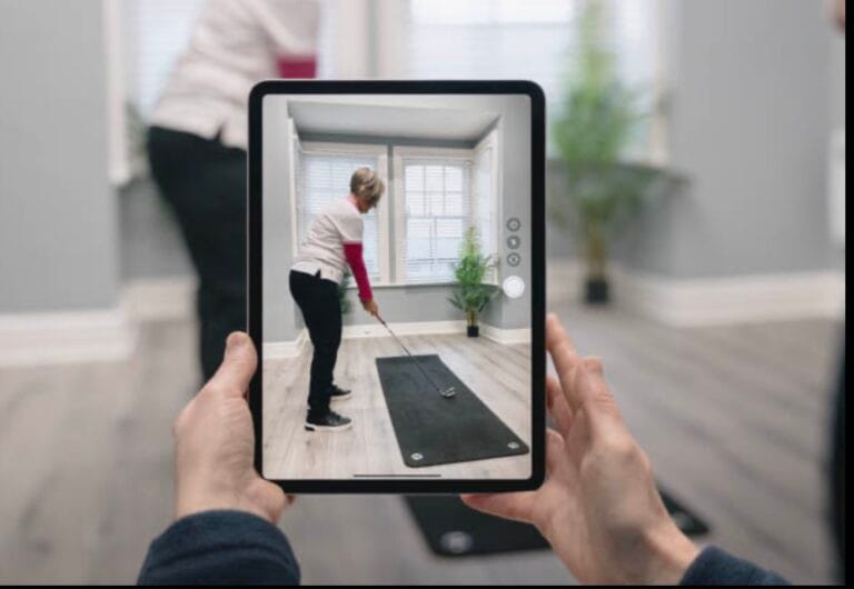 Tablet showing woman practising golf indoors