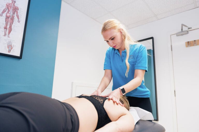 Physiotherapist performing back treatment in clinic