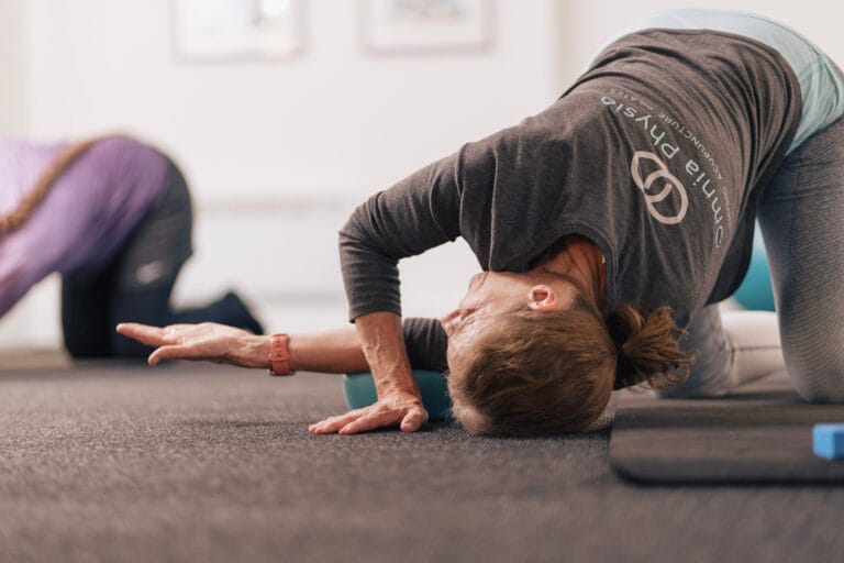 Women stretching during indoor yoga class
