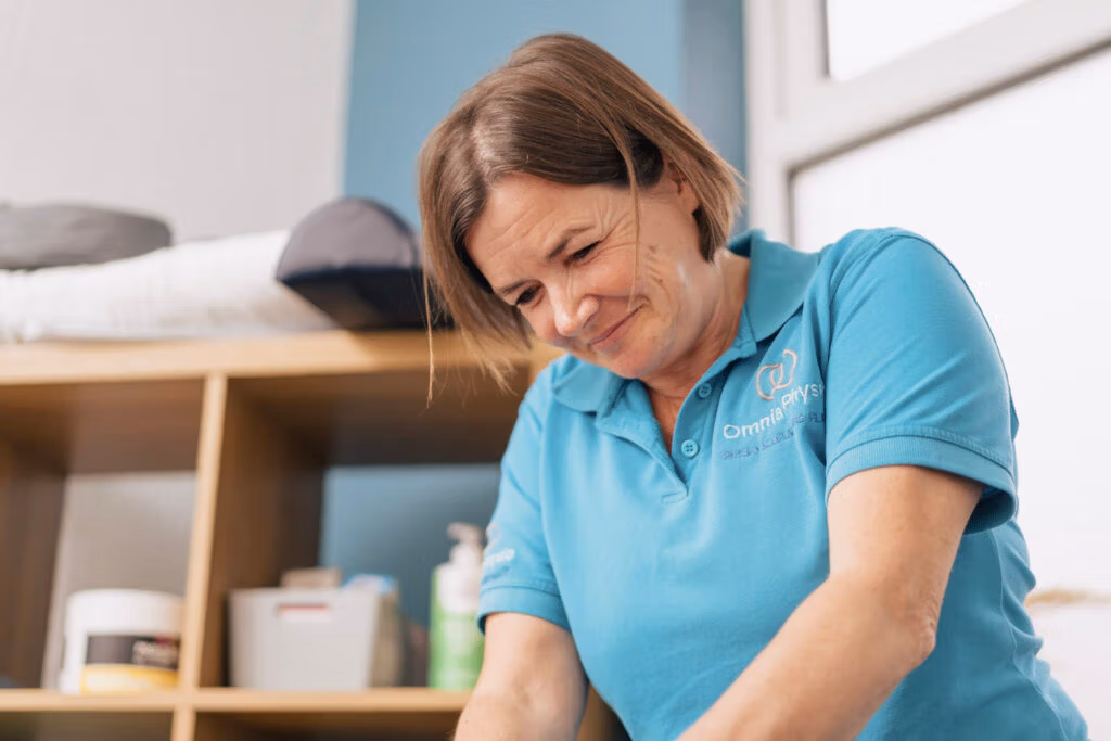 Physiotherapist treating a patient in a clinical room