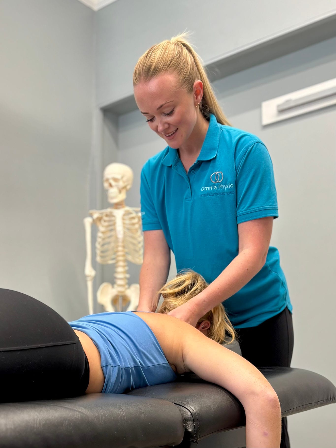 Physiotherapist treating patient's neck on therapy table